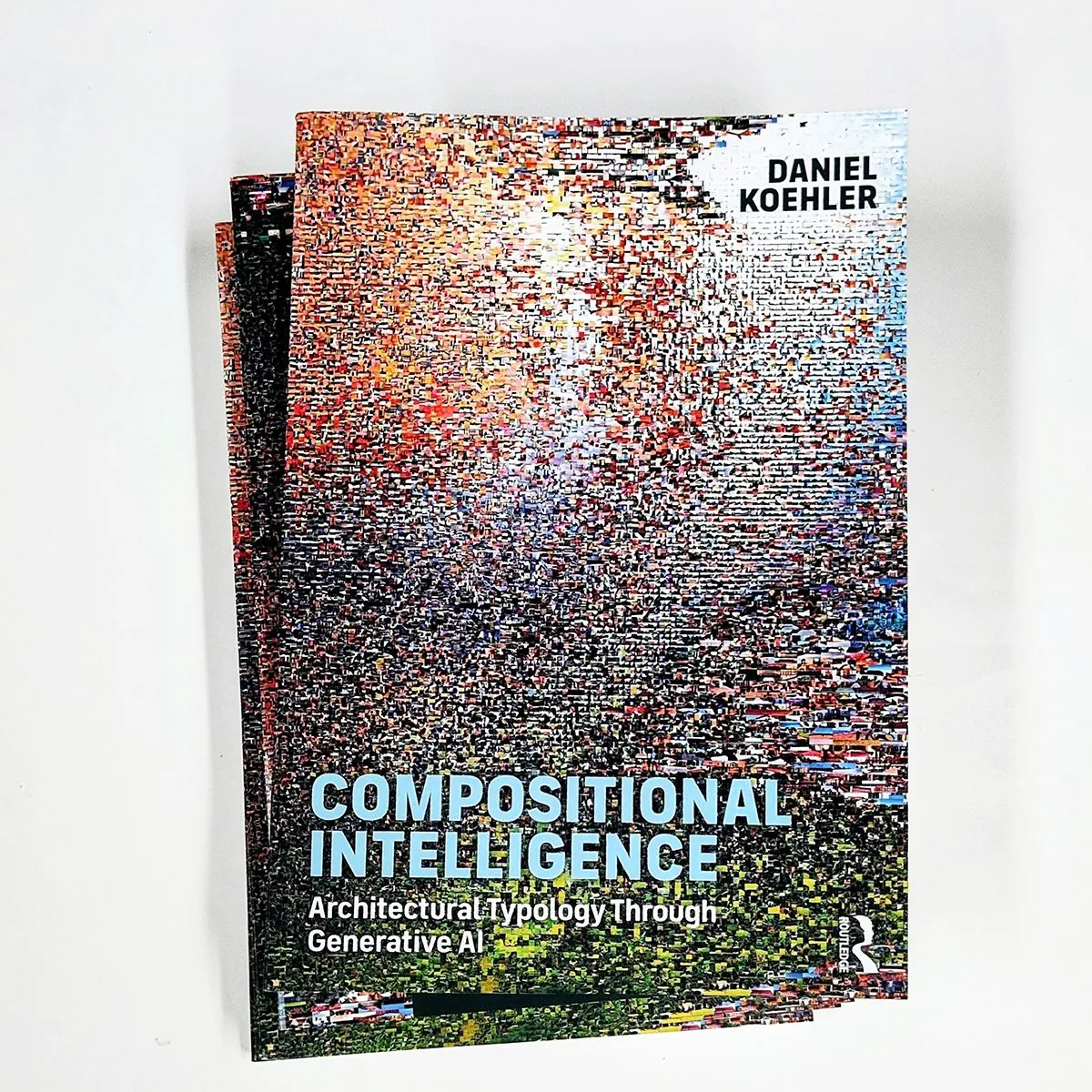 Two copies of the book Compositional Intelligence, the cover a mosaic of thousands of tiny generated city images