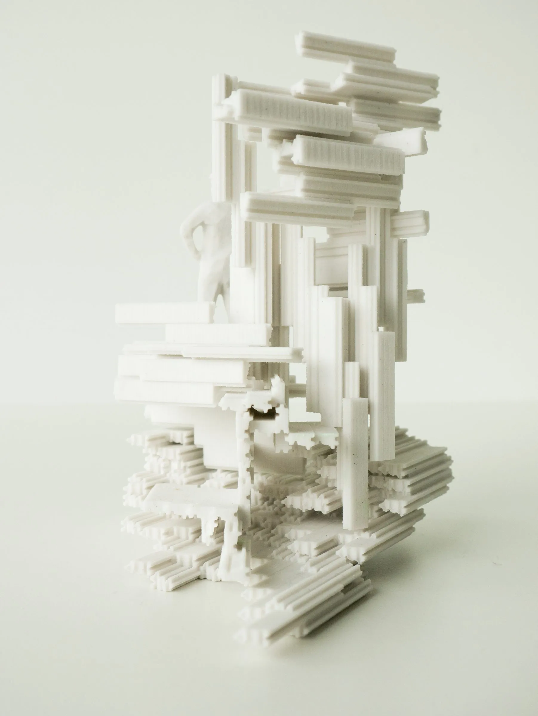 The white model standing upright, its frames stacked into a tower