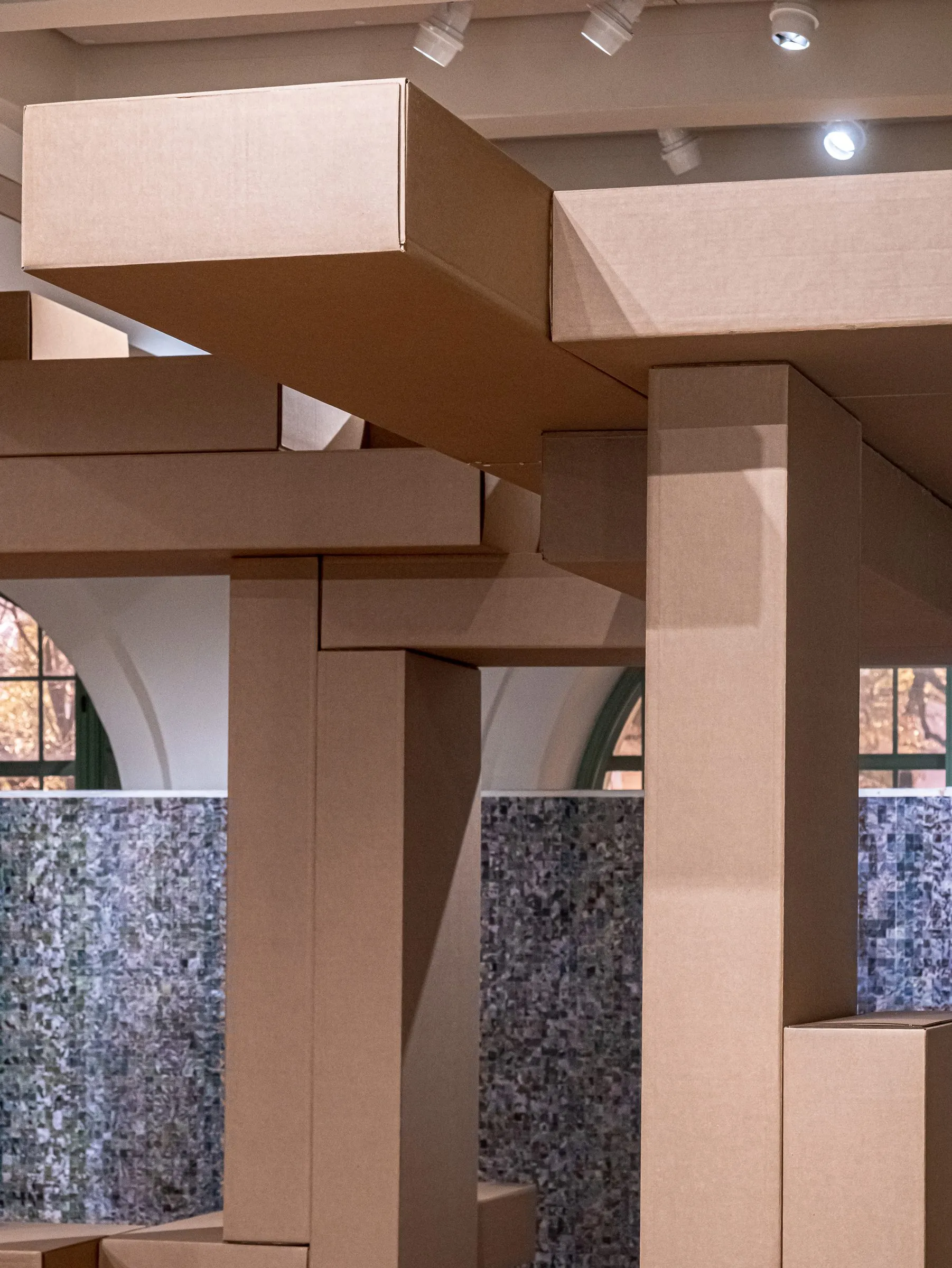 Detail of the cardboard construction: beams stacked and crossed under the ceiling