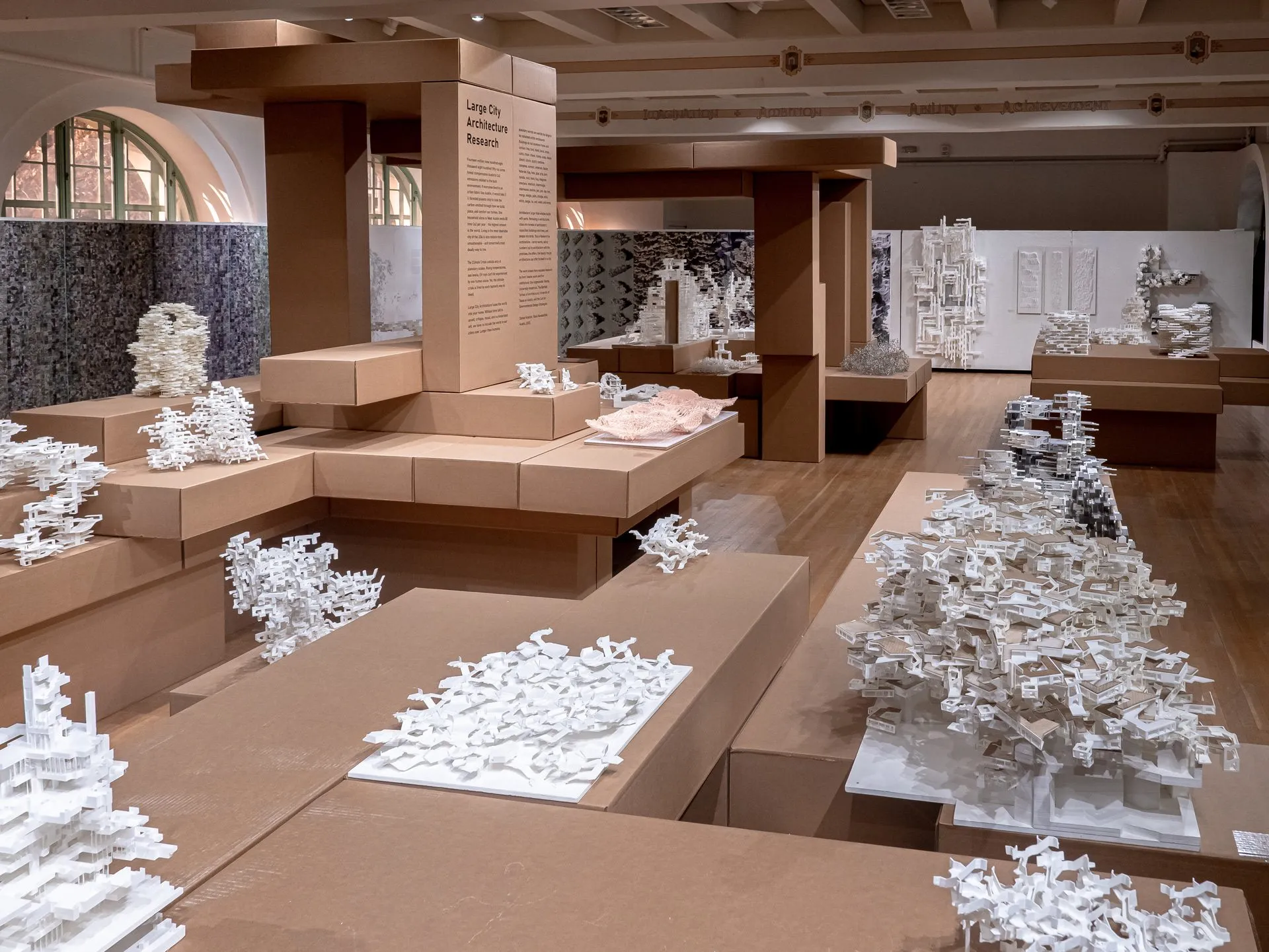 Close view of white models on a cardboard platform