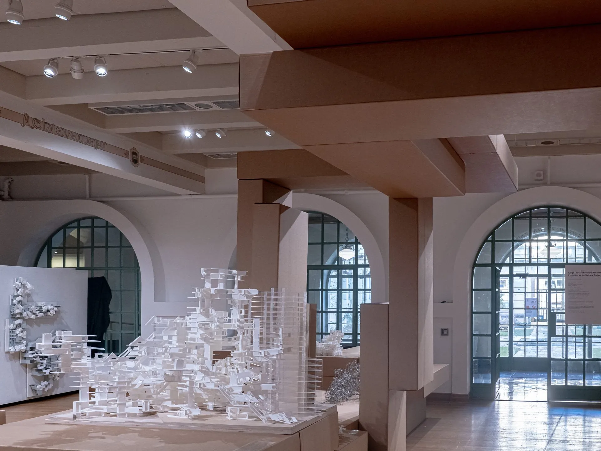 Models seen against the arched windows of the gallery