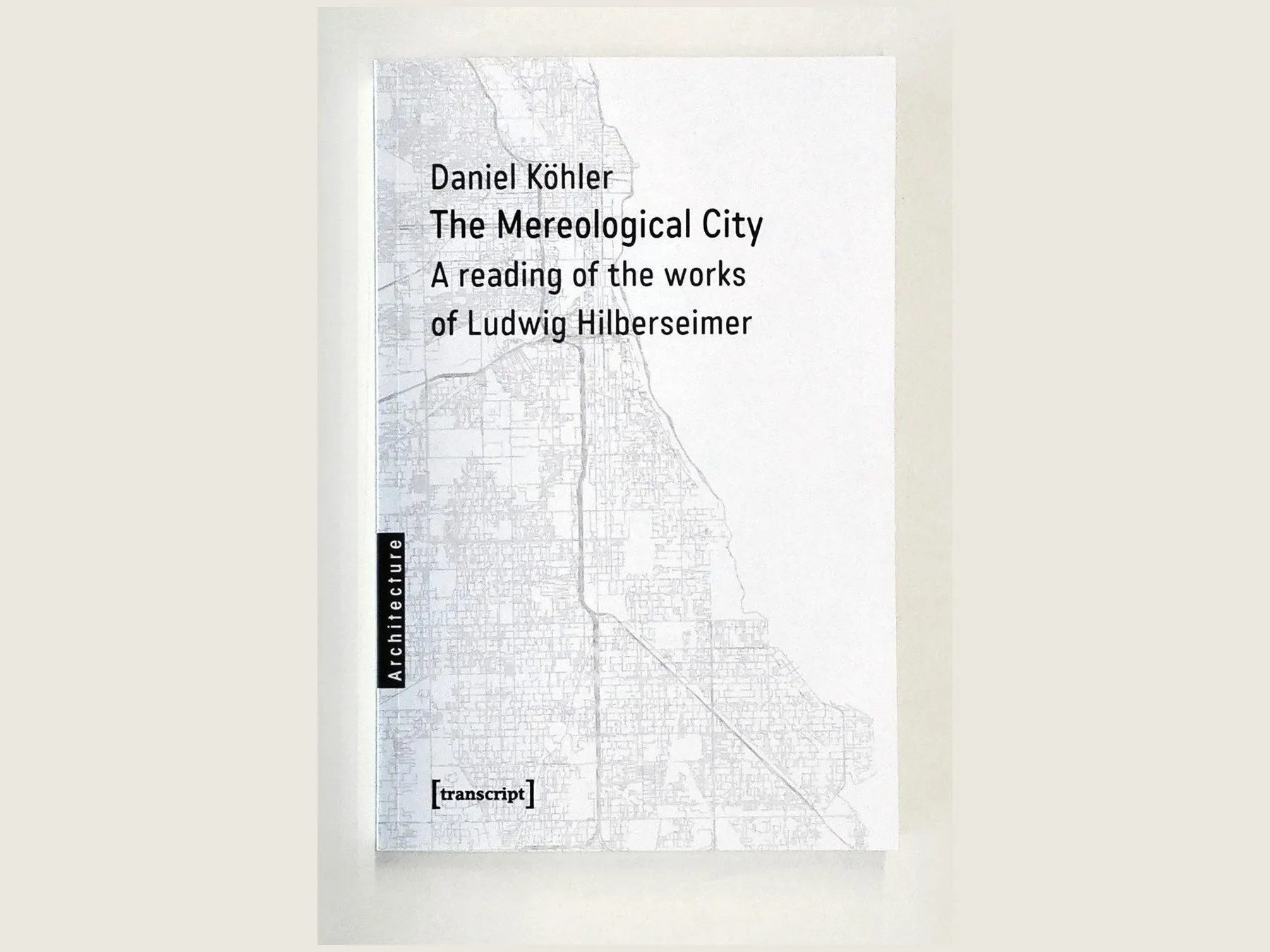 The cover of The Mereological City, centred: a street map of Chicago in grey with the title in black