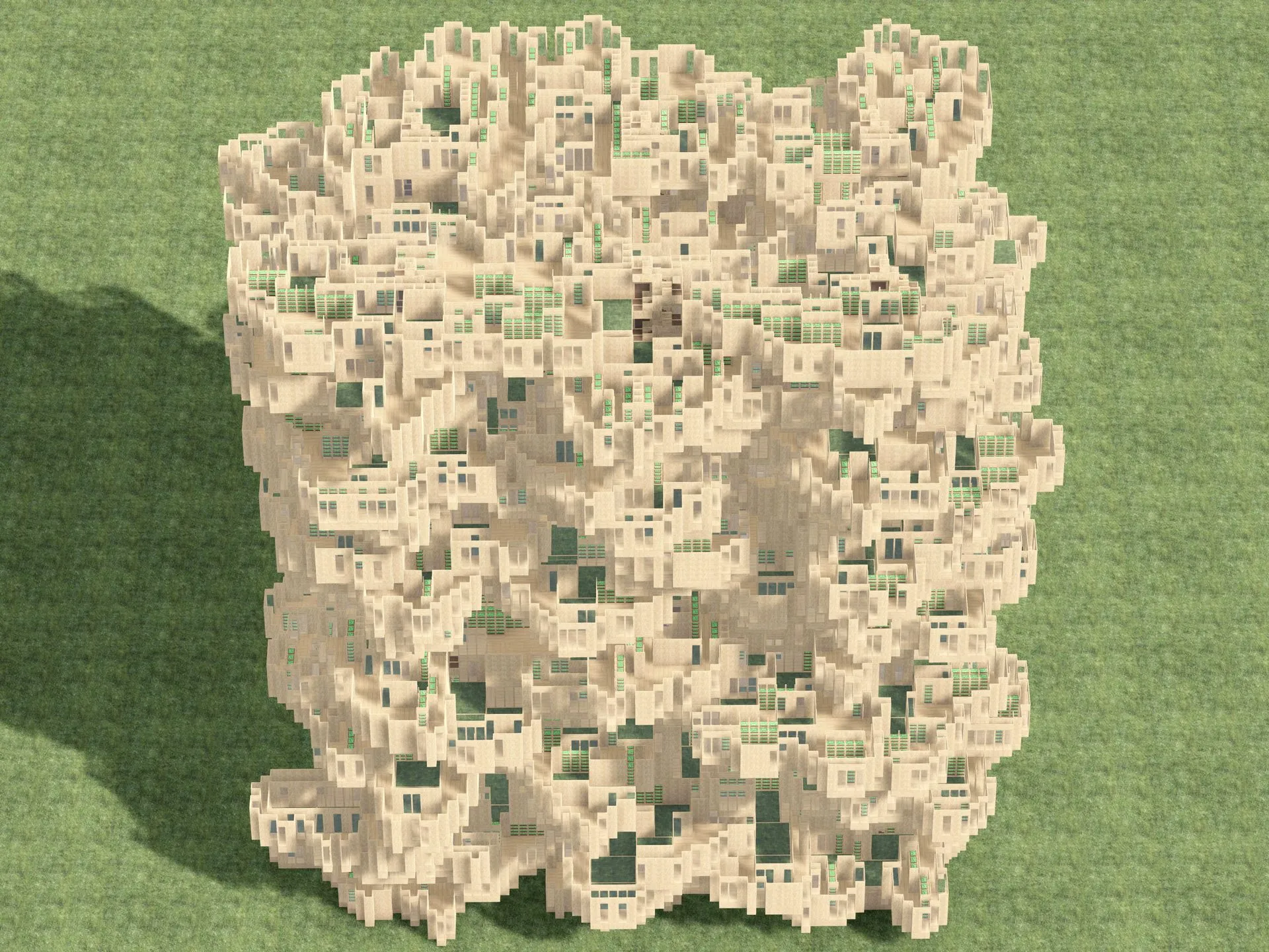 A cubic aggregate of sand-colored rooms and terraces with green courtyards, seen from above on a green ground