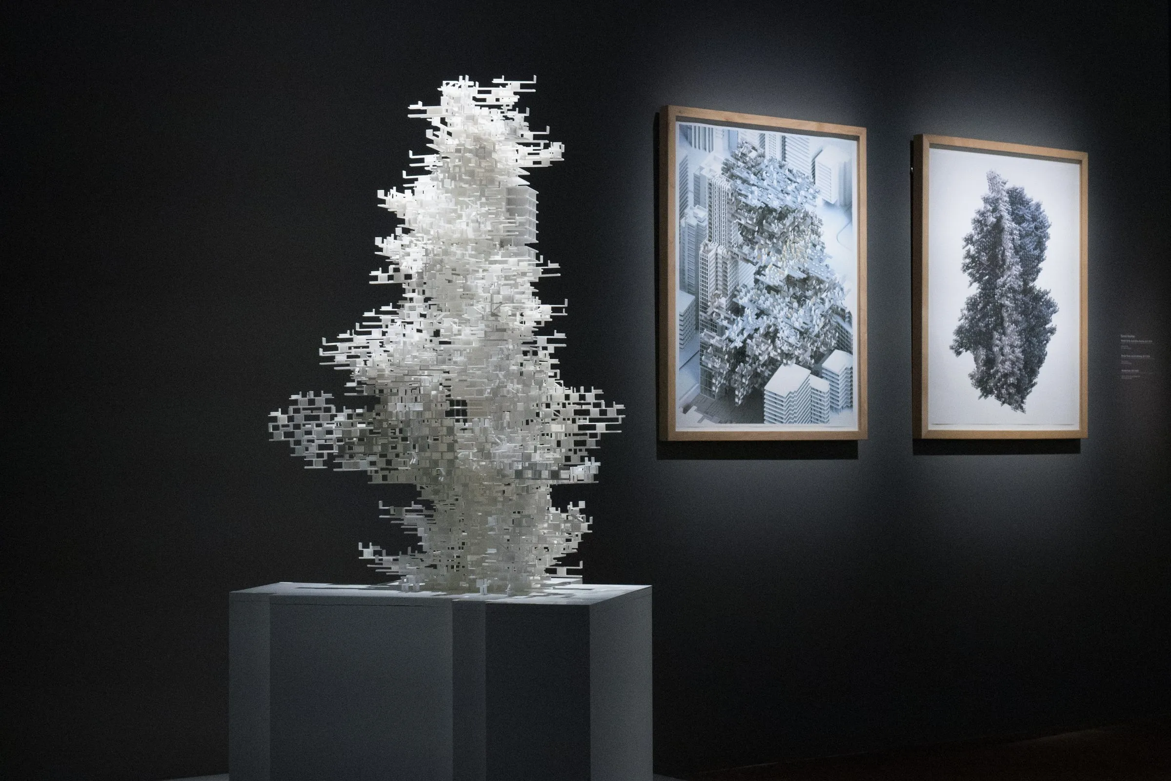 The white WanderYards model on a plinth beside two framed drawings