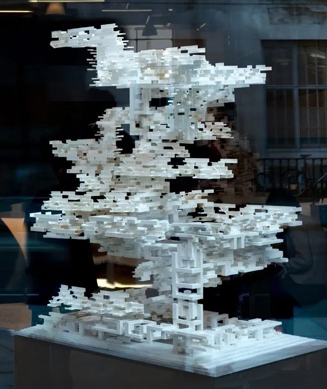 A white model of Enframes in a vitrine