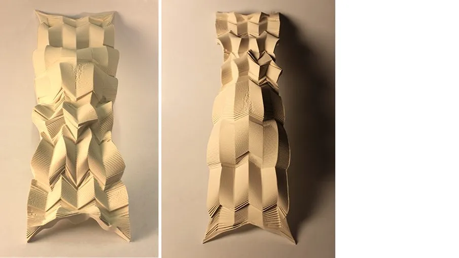 Two folded paper columns standing side by side, lit from the left