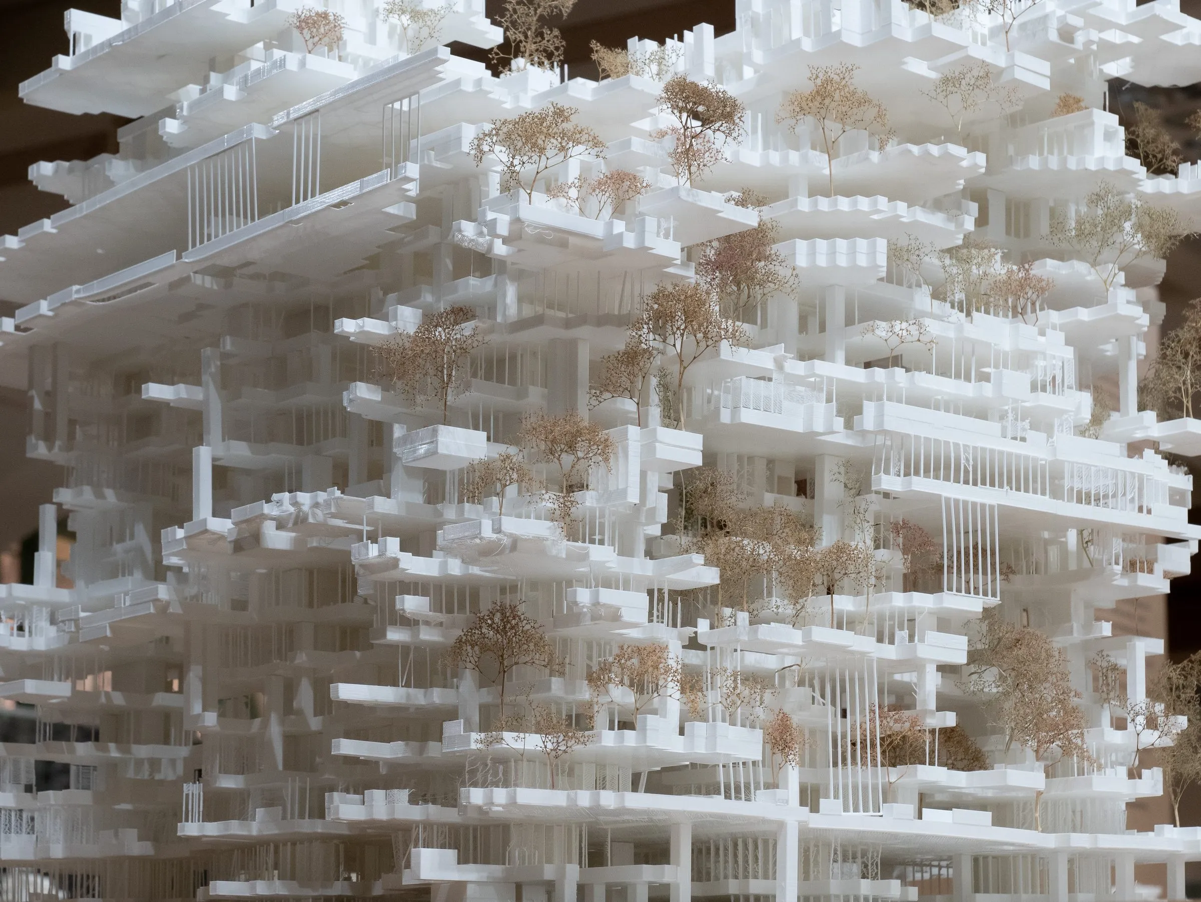 Close view of the model: thin columns carrying stacked slabs, with trees between the levels