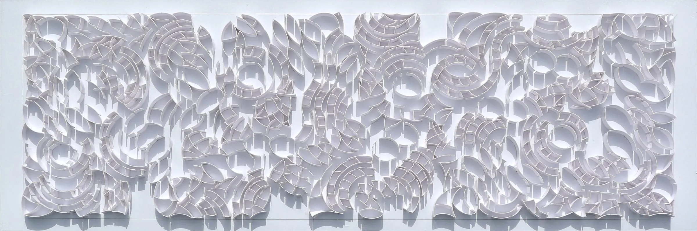 A long strip of white model pieces reading as a fragment of the Manhattan grid turned inside out