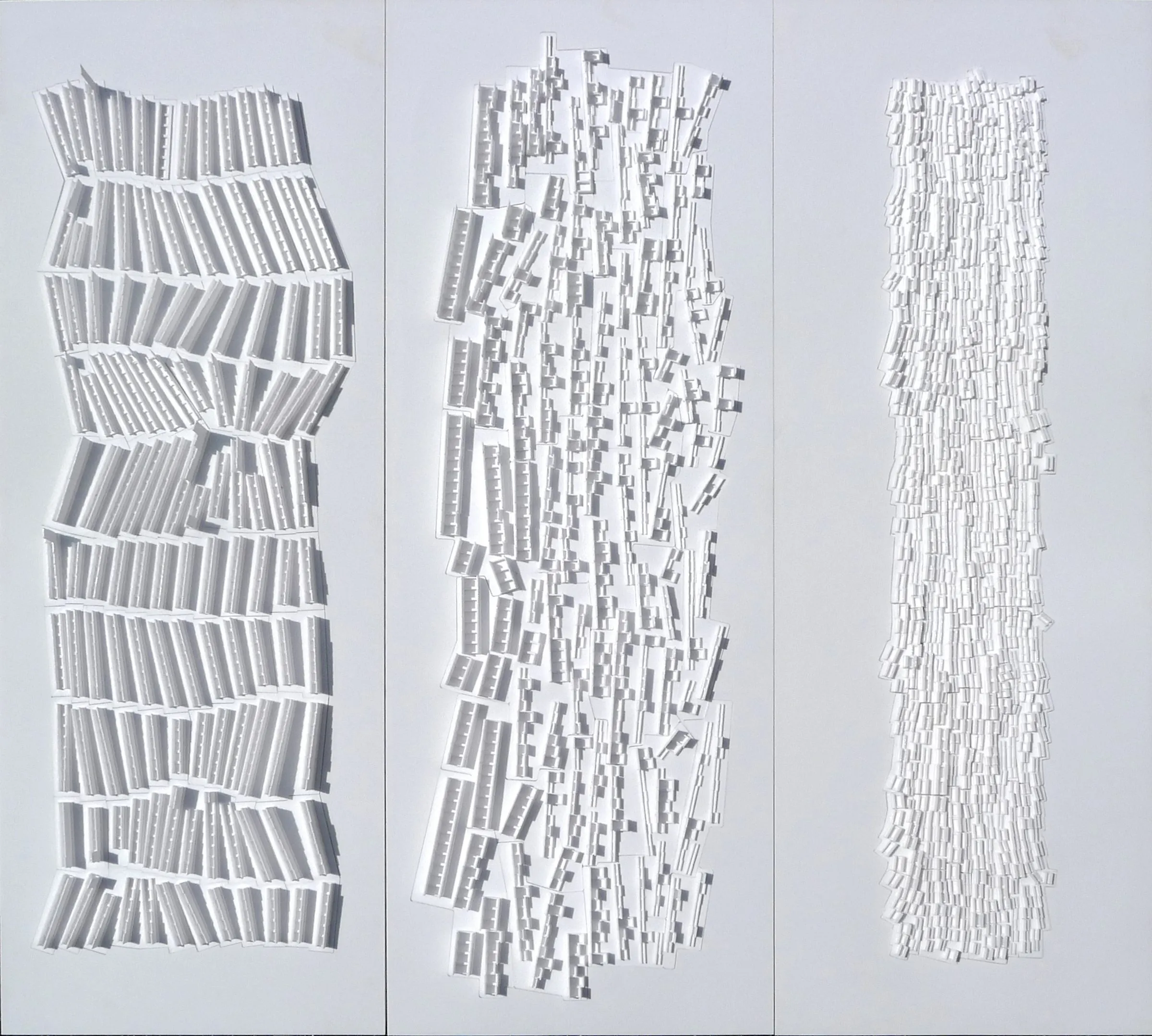 Three white relief panels side by side, each rendering Hilberseimer's Vertical City at a finer grain of cells