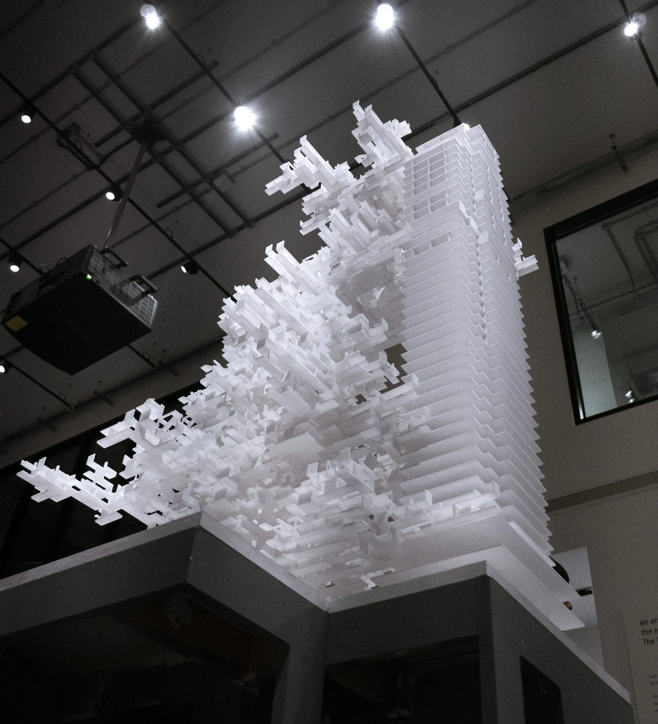 Looking up at the white tower model against the ceiling lights of the show