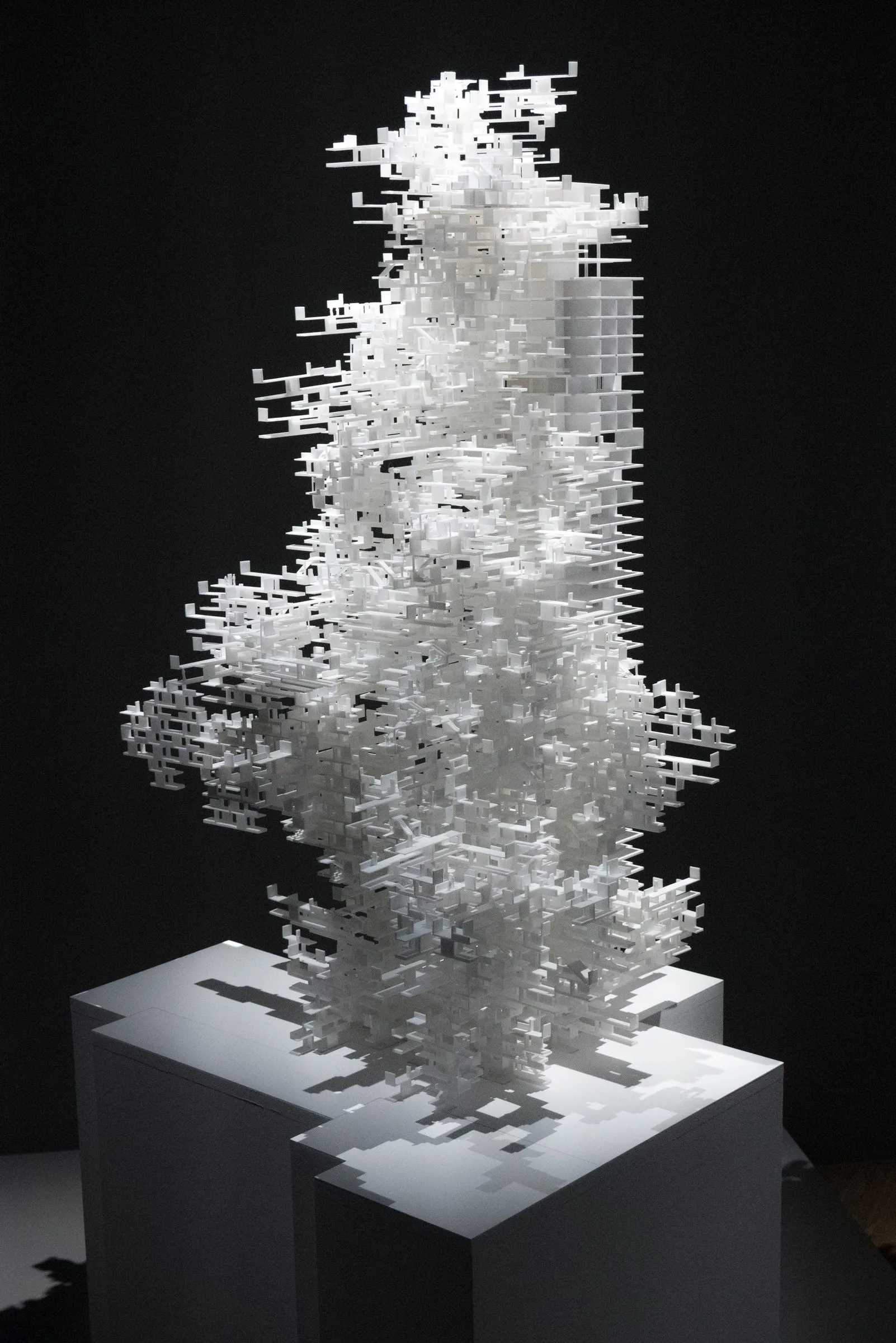 The white 3D-printed WanderYards model standing on a pale plinth against a black wall